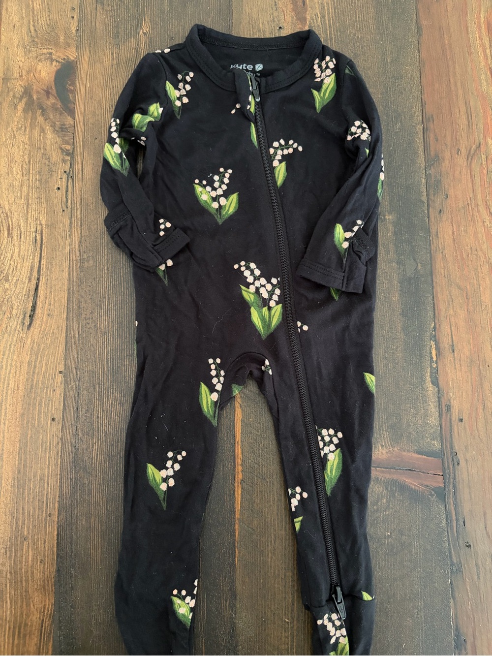 Kyte BABY Black Footed One-Piece with White Floral and Green Leaves